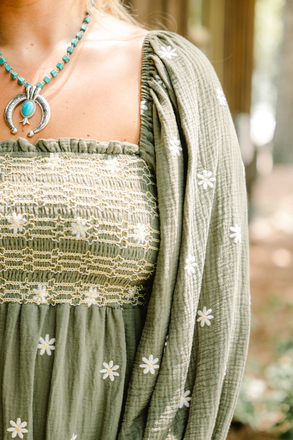 Chic Soul plus size clothing, olive baby doll dress with long sleeves that have a ruffle detail at each end of the sleeve as well as a white floral pattern throughout and stitching detail on the bust 