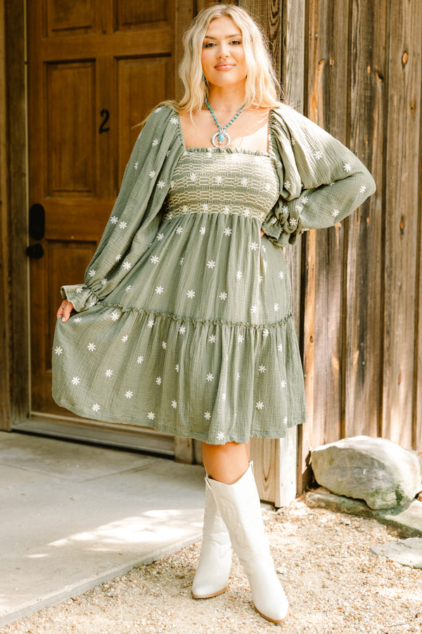 Chic Soul plus size clothing, olive baby doll dress with long sleeves that have a ruffle detail at each end of the sleeve as well as a white floral pattern throughout and stitching detail on the bust 