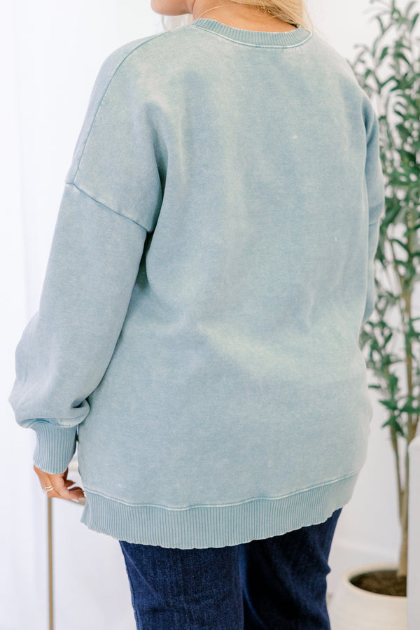 Light blue sweatshirt worn by a person with a white background