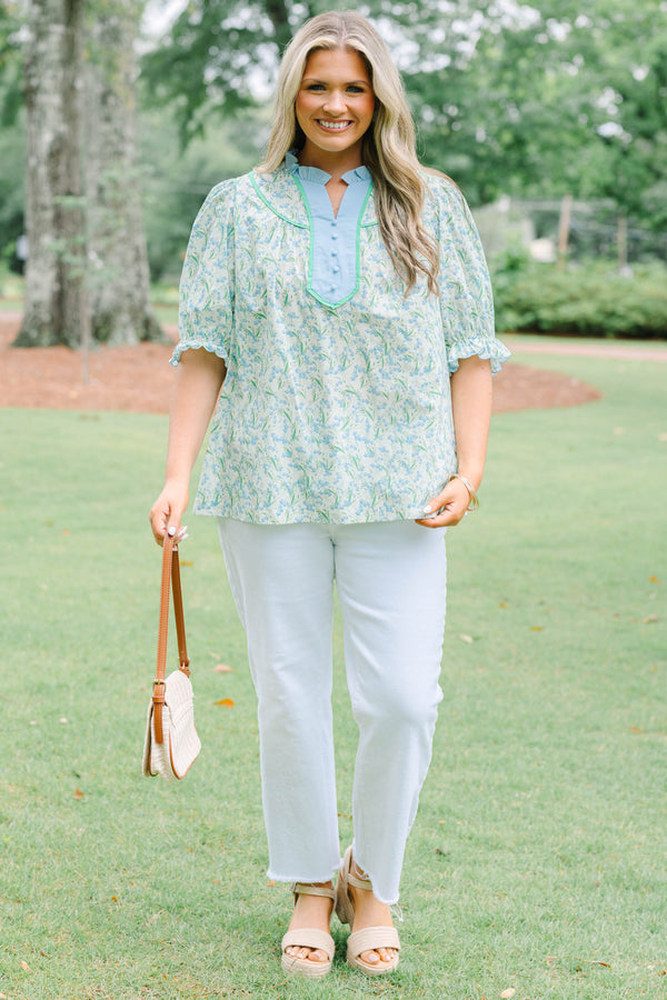 Plus Size blue floral top with a ruffled collar, buttoned bib, and short puff sleeves.