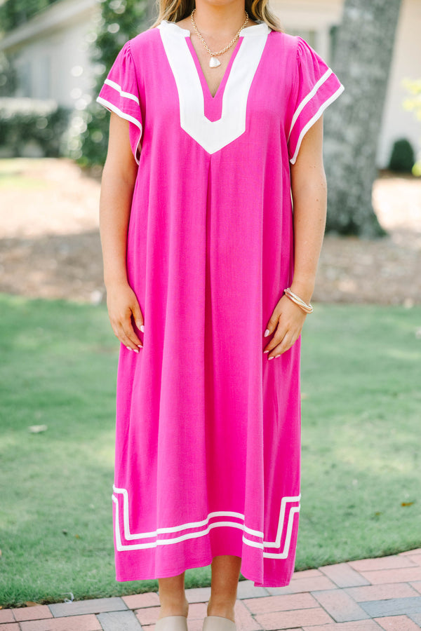Plus size pink maxi dress with white trim, V-neckline, and flowy short sleeves.