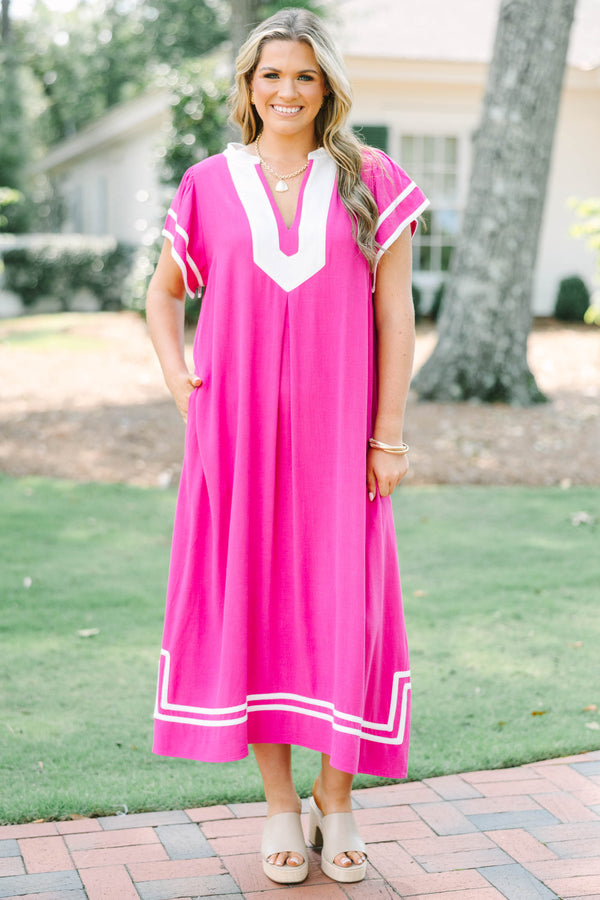 Plus size pink maxi dress with white trim, V-neckline, and flowy short sleeves.