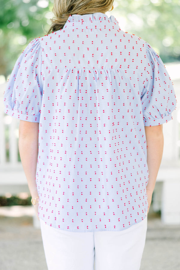 Plus Size blue gingham button-down top with red embroidery, ruffled collar, and puff sleeves.