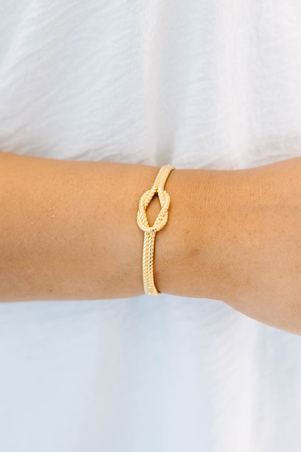 Plus Size gold bracelet with a twisted rope texture and a central knot design.