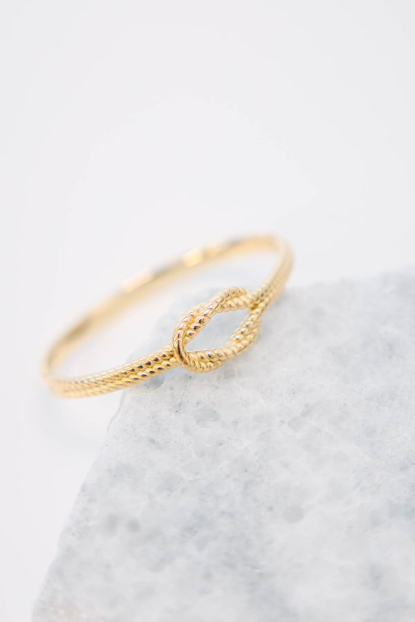 Plus Size gold bracelet with a twisted rope texture and a central knot design.