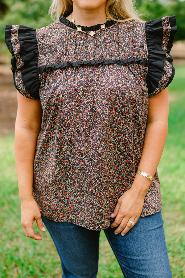 Chic Soul plus size clothing, black top with a small multi color floral pattern and flutter sleeves that have ruffle detailing 