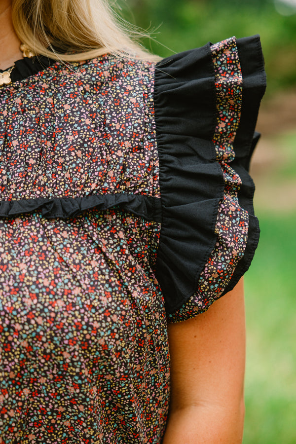 Chic Soul plus size clothing, black top with a small multi color floral pattern and flutter sleeves that have ruffle detailing 