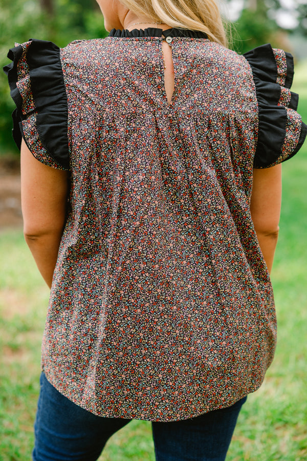 Chic Soul plus size clothing, black top with a small multi color floral pattern and flutter sleeves that have ruffle detailing 