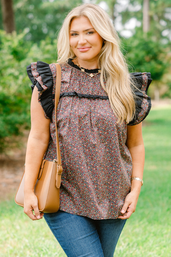 Chic Soul plus size clothing, black top with a small multi color floral pattern and flutter sleeves that have ruffle detailing 