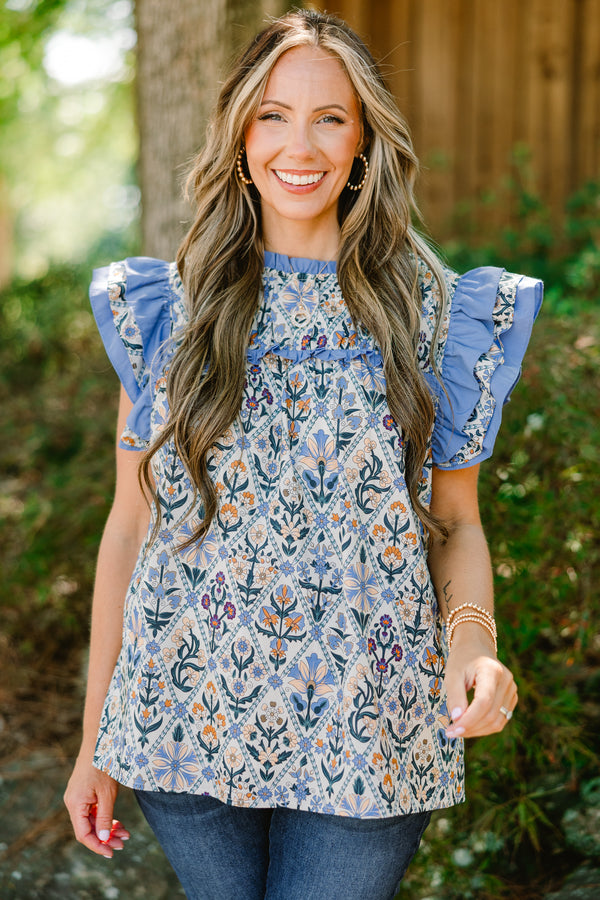 Chic Soul plus size clothing, blue floral print short flutter sleeve top with blue ruffles on sleeves and across top of chest
