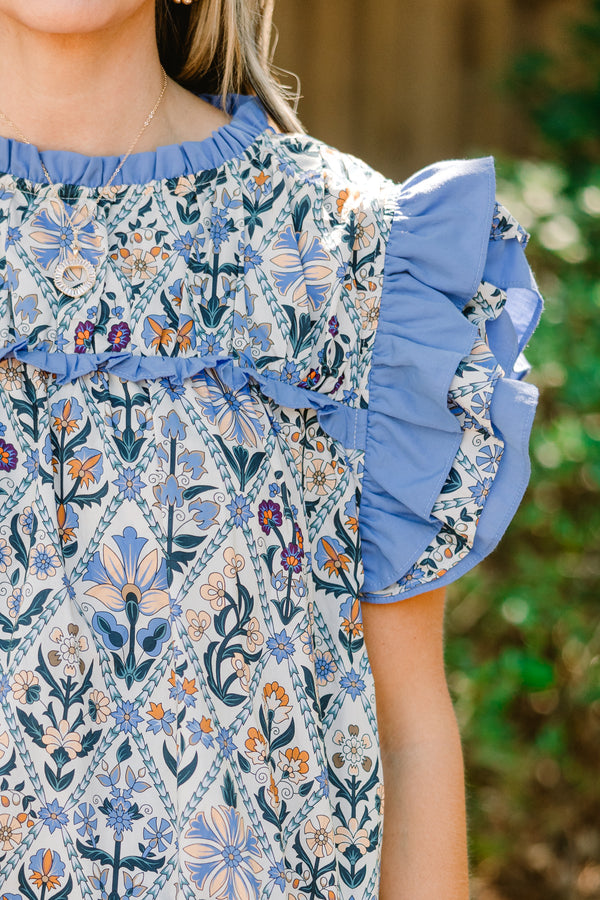Chic Soul plus size clothing, blue floral print short flutter sleeve top with blue ruffles on sleeves and across top of chest
