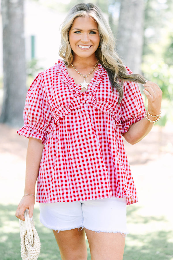 Plus size red and white gingham top with ruffle neck and puff sleeves.