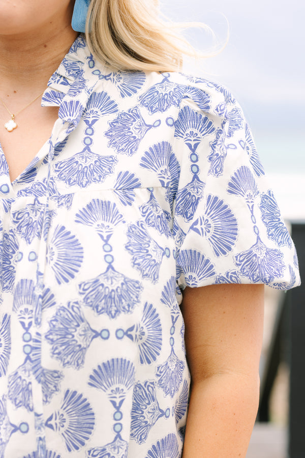 Chic Soul plus size clothing, blue and white patterned short puff sleeve top with button up ruffle collar and tassels on either side of the collar
