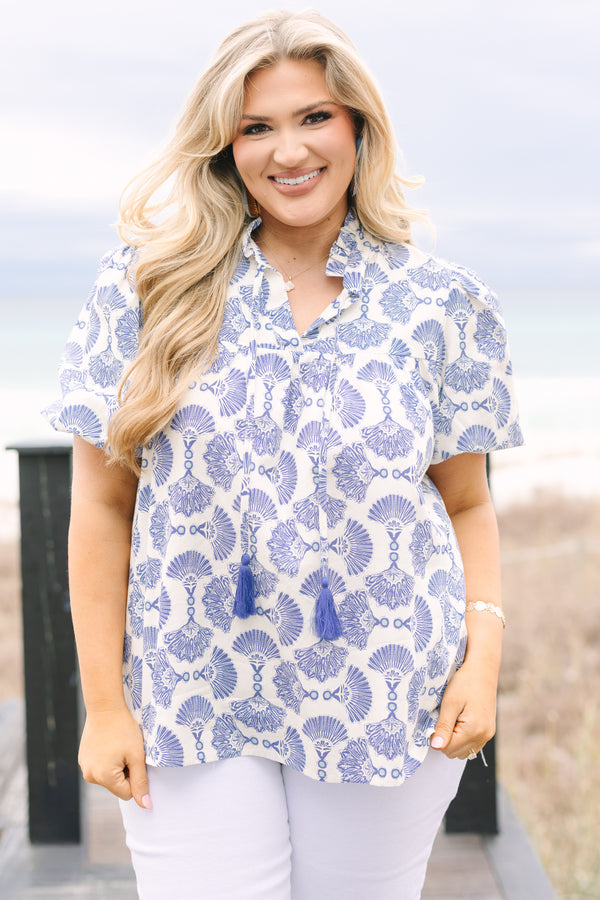 Chic Soul plus size clothing, blue and white patterned short puff sleeve top with button up ruffle collar and tassels on either side of the collar
