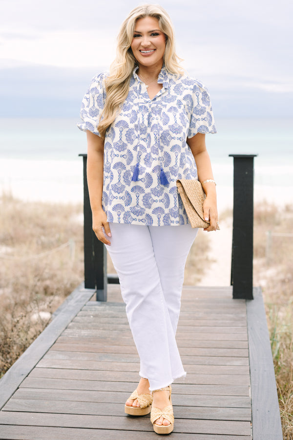 Chic Soul plus size clothing, blue and white patterned short puff sleeve top with button up ruffle collar and tassels on either side of the collar
