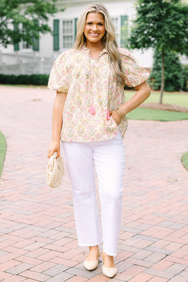 Plus Size pink floral print top with puff sleeves, a ruffled neckline, and tassel details.