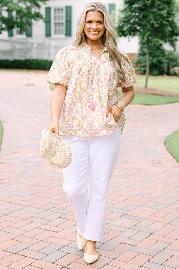Plus Size pink floral print top with puff sleeves, a ruffled neckline, and tassel details.
