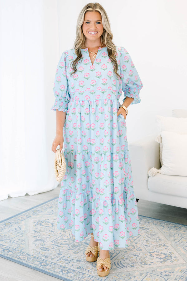 Plus size baby blue tiered maxi dress with pink floral print, ruffle sleeves, and a flowy fit.