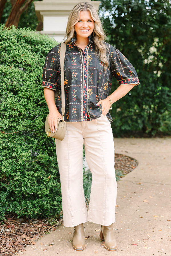 Plus size black cotton button-up top with multi-floral print, puff sleeves, and ruffled collar.