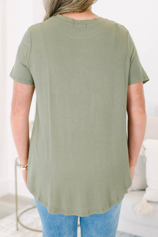 Plus size olive green top with a flowy fit and short sleeves.