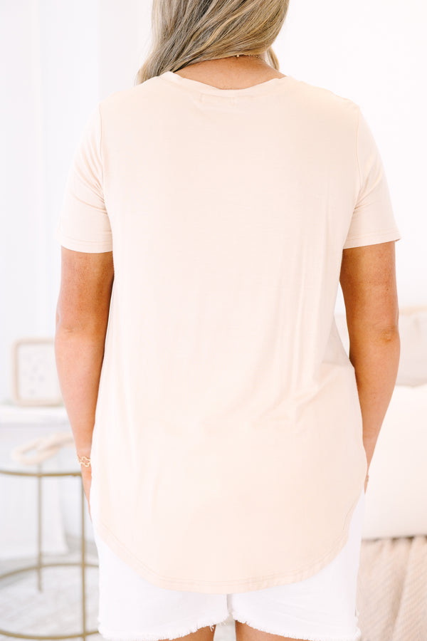 Plus Size sand-colored short sleeve tunic top with a round neckline and curved hem.