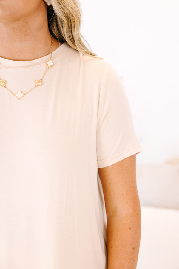 Plus Size sand-colored short sleeve tunic top with a round neckline and curved hem.