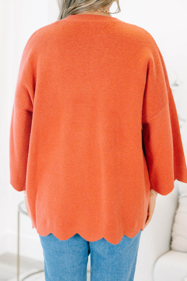 Plus Size rust-colored oversized knit sweater with a crew neckline and scalloped hem.