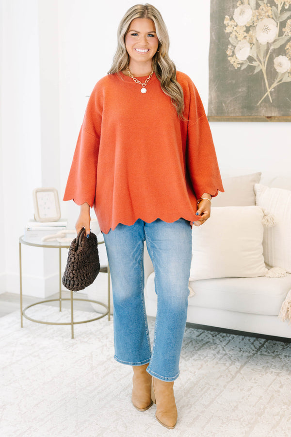 Plus Size rust-colored oversized knit sweater with a crew neckline and scalloped hem.