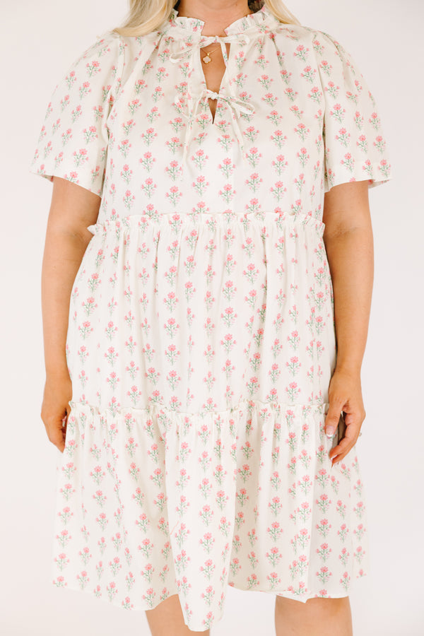 Chic Soul plus size clothing, cream tiered knee length dress with a pink floral pattern as well as two bows that tie  on the across the v-neckline 