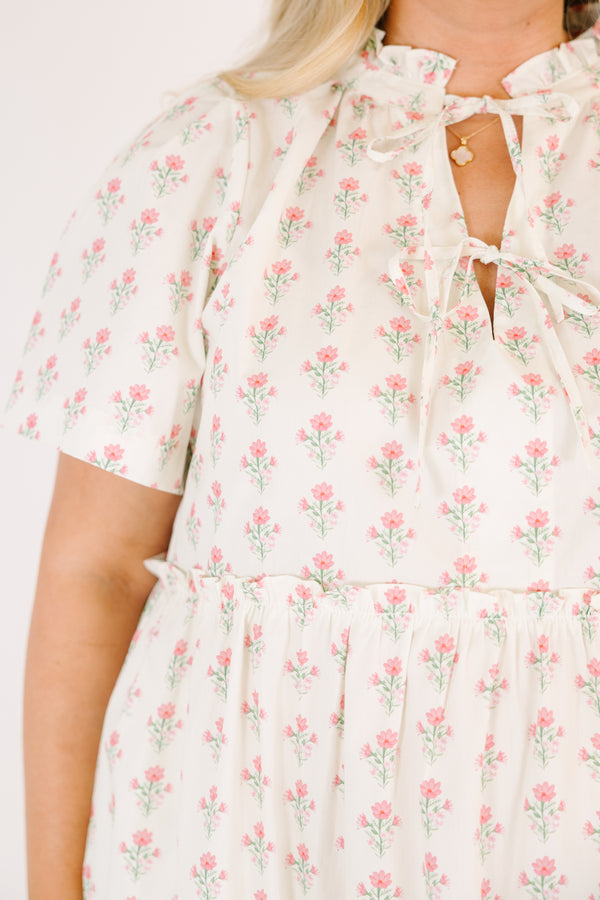 Chic Soul plus size clothing, cream tiered knee length dress with a pink floral pattern as well as two bows that tie  on the across the v-neckline 