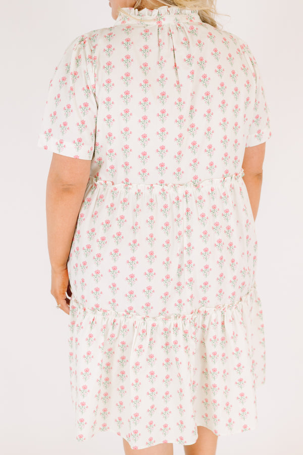 Chic Soul plus size clothing, cream tiered knee length dress with a pink floral pattern as well as two bows that tie  on the across the v-neckline 