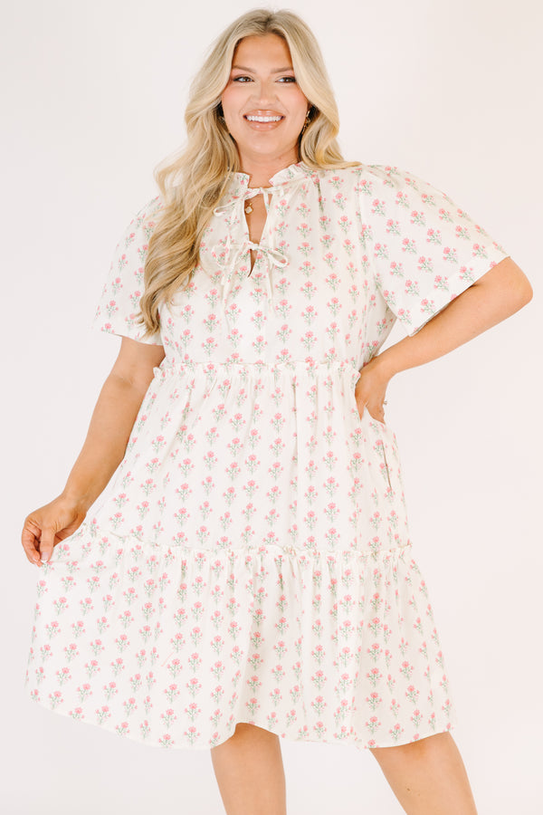 Chic Soul plus size clothing, cream tiered knee length dress with a pink floral pattern as well as two bows that tie  on the across the v-neckline 