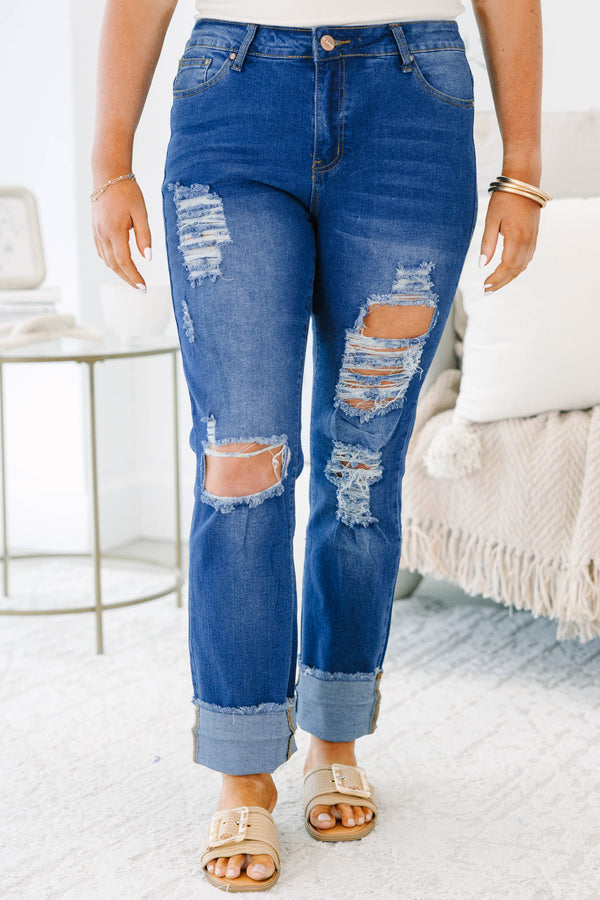 Plus size distressed denim jeans with a straight leg fit, frayed cuffs, and a medium wash.