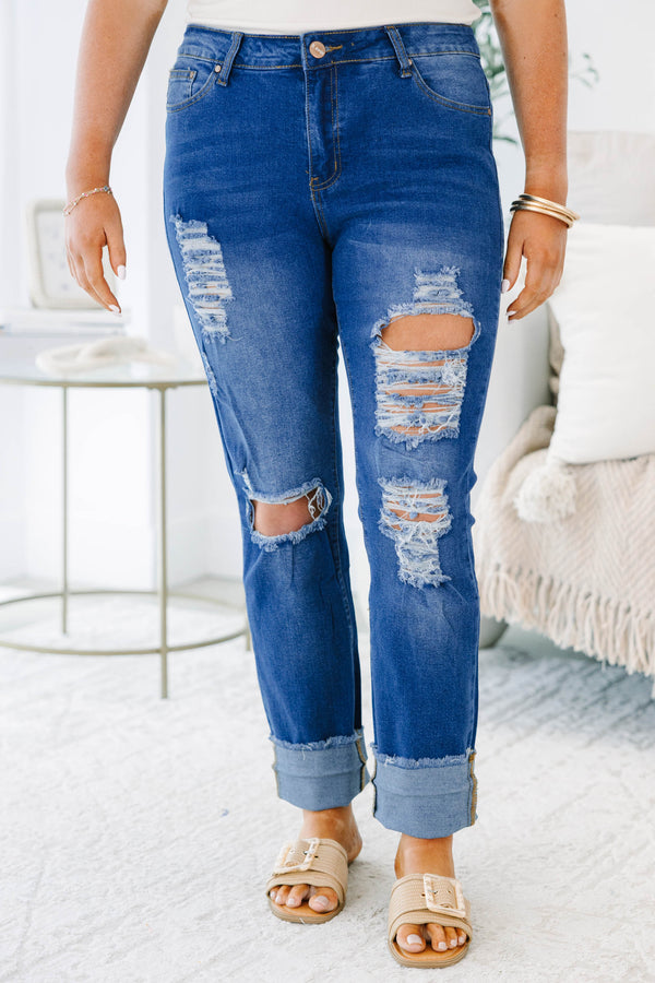 Plus size distressed denim jeans with a straight leg fit, frayed cuffs, and a medium wash.