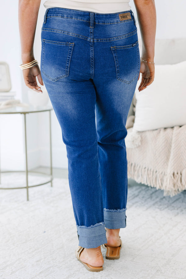 Plus size distressed denim jeans with a straight leg fit, frayed cuffs, and a medium wash.