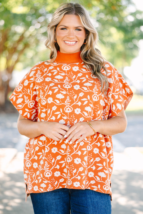 Plus Size rust orange short sleeve mock neck sweater with a white floral knit pattern.
