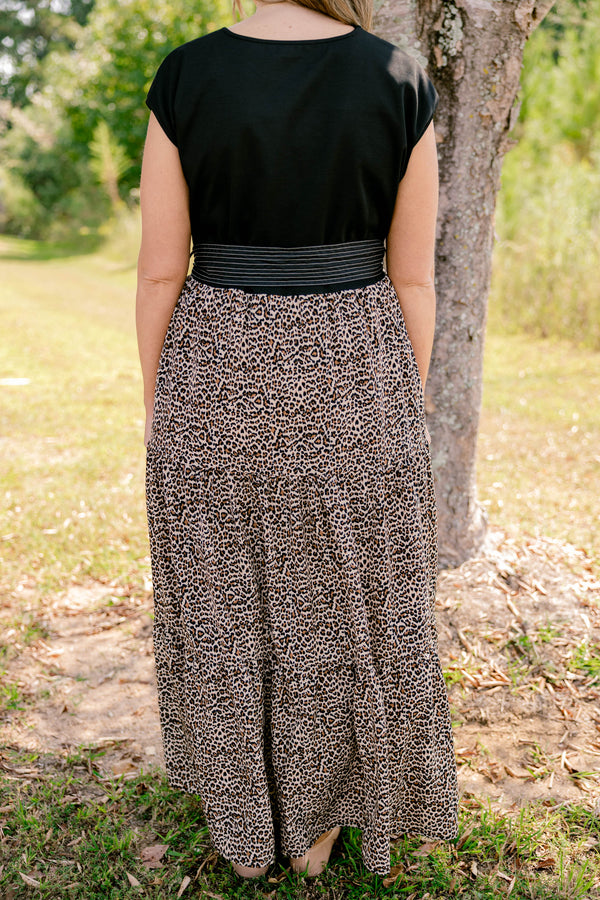 Chic Soul plus size clothing, maxi dress that has a shot sleeve solid black top and a leopard pattern tiered skirt that starts at the waistline as well as a bow that ties around the waist 