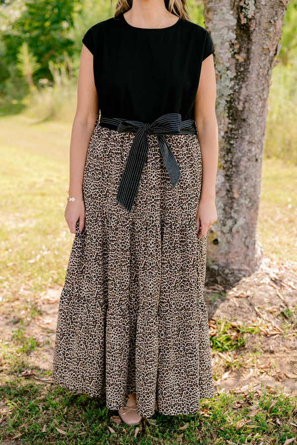 Chic Soul plus size clothing, maxi dress that has a shot sleeve solid black top and a leopard pattern tiered skirt that starts at the waistline as well as a bow that ties around the waist 