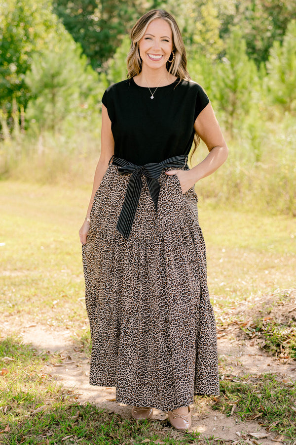 Chic Soul plus size clothing, maxi dress that has a shot sleeve solid black top and a leopard pattern tiered skirt that starts at the waistline as well as a bow that ties around the waist 