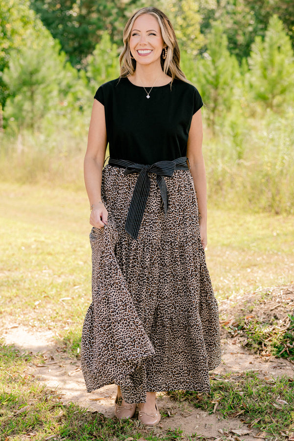 Chic Soul plus size clothing, maxi dress that has a shot sleeve solid black top and a leopard pattern tiered skirt that starts at the waistline as well as a bow that ties around the waist 