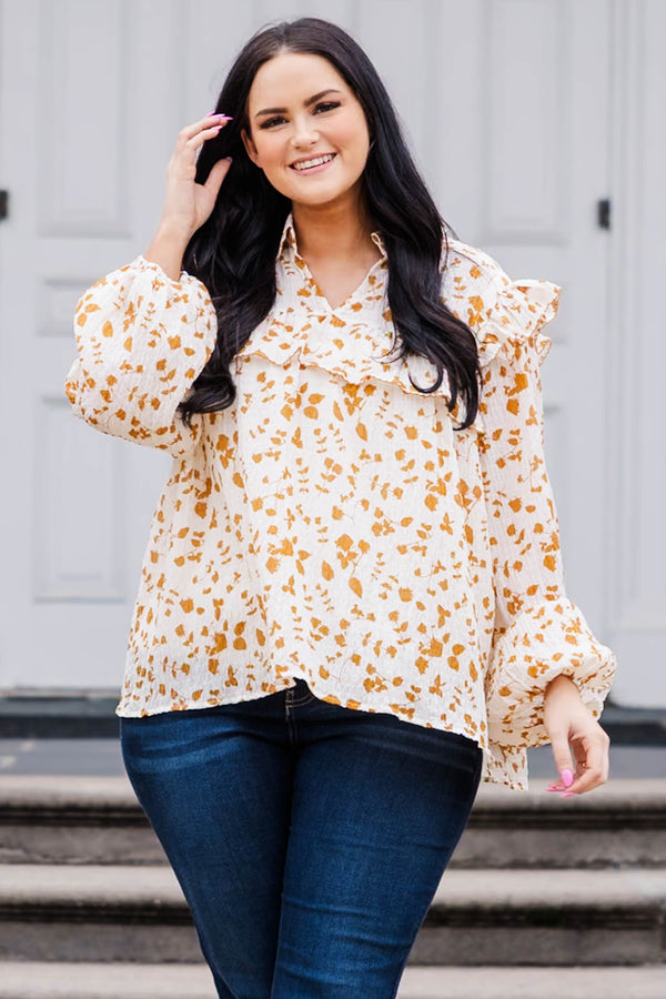 Chic Soul plus size clothing, white and orange patterned long sleeve top with v neckline and ruffle detailing and puff sleeves at the bottom