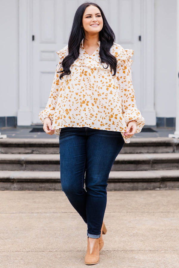 Chic Soul plus size clothing, white and orange patterned long sleeve top with v neckline and ruffle detailing and puff sleeves at the bottom