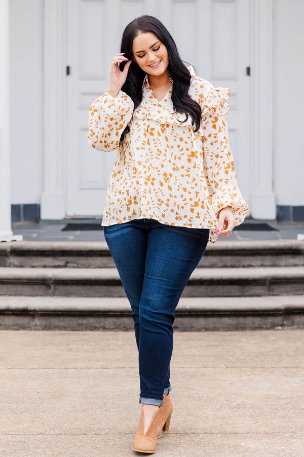 Chic Soul plus size clothing, white and orange patterned long sleeve top with v neckline and ruffle detailing and puff sleeves at the bottom