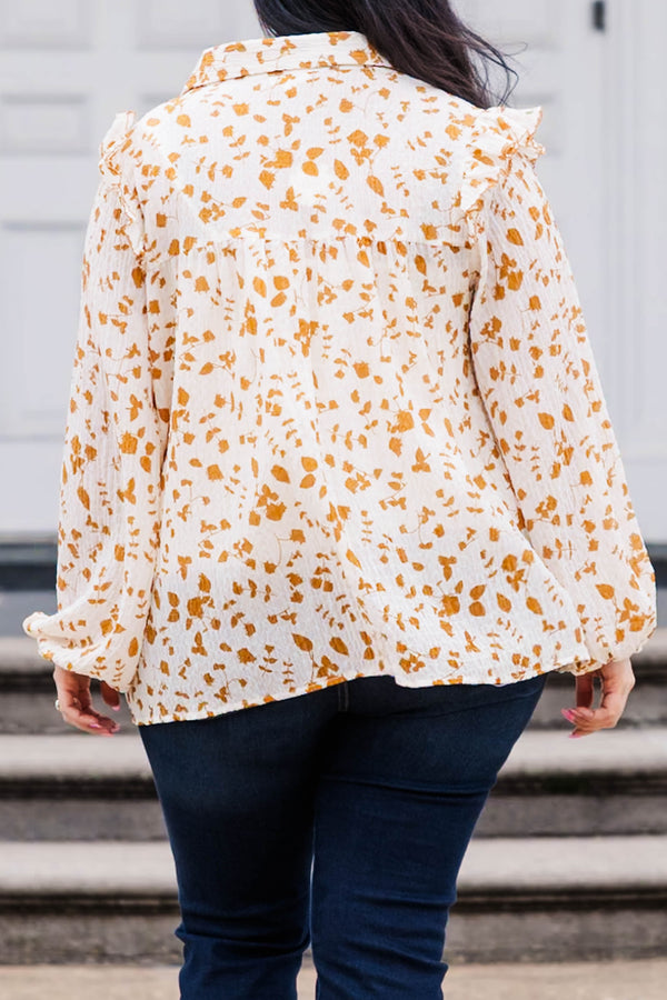 Chic Soul plus size clothing, white and orange patterned long sleeve top with v neckline and ruffle detailing and puff sleeves at the bottom