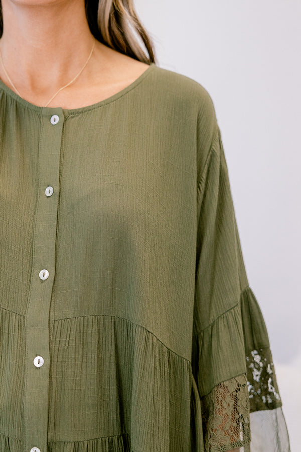 Chic Soul plus size clothing, olive long sleeve blouse with sheer lace details on the bottom of the shirt as well as at the end of each sleeve and buttons going down the middle of the top 