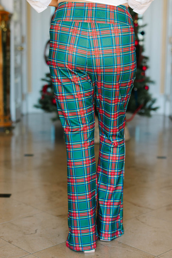 Plus size green plaid flare pants with a stretchy, high-waisted fit and a festive holiday pattern.