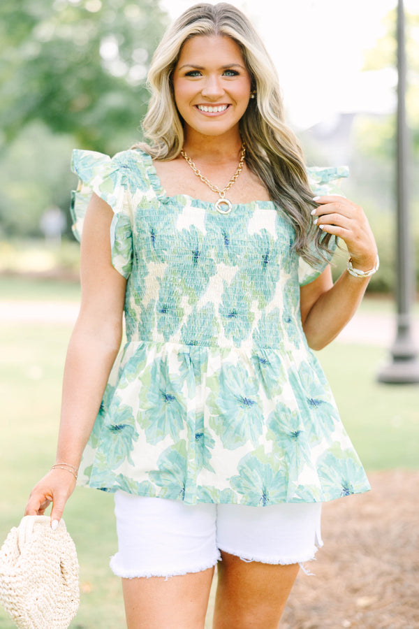 Plus size sea green floral smocked top with ruffle sleeves and a flowy peplum silhouette.