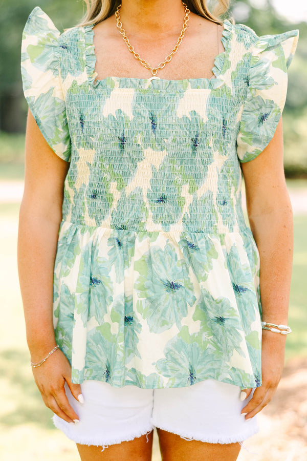Plus size sea green floral smocked top with ruffle sleeves and a flowy peplum silhouette.
