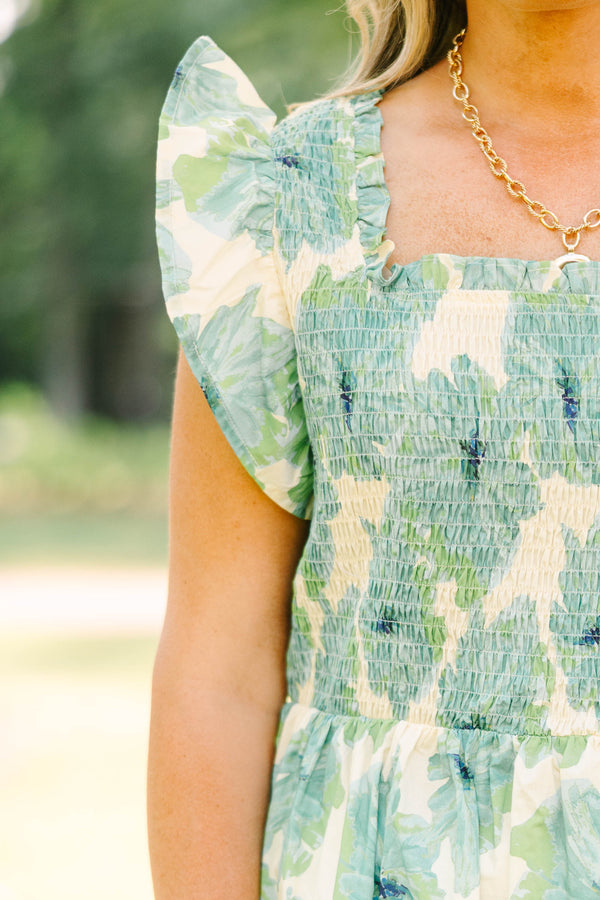 Plus size sea green floral smocked top with ruffle sleeves and a flowy peplum silhouette.