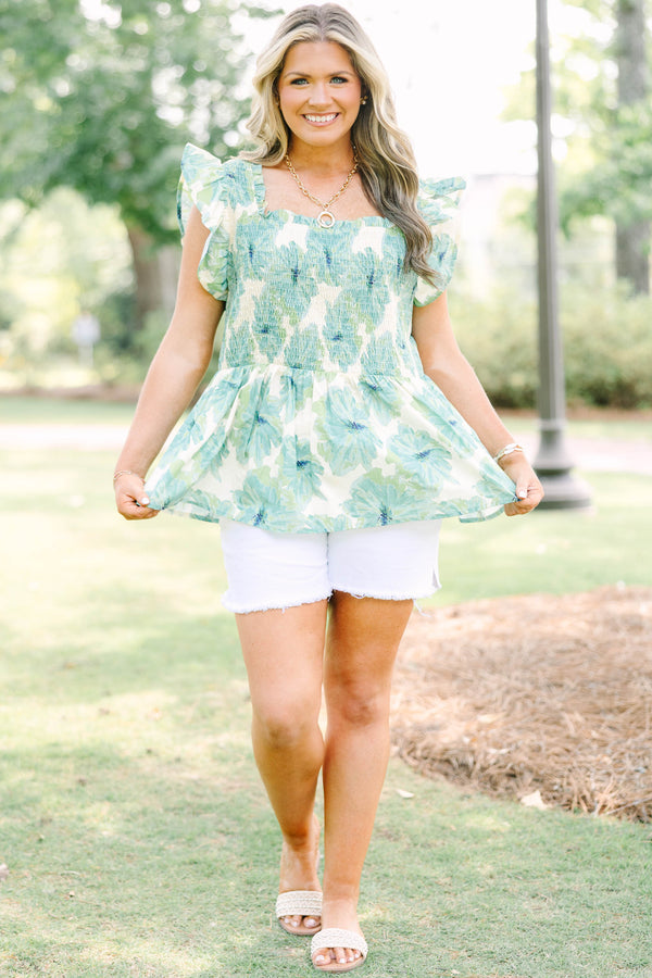 Plus size sea green floral smocked top with ruffle sleeves and a flowy peplum silhouette.